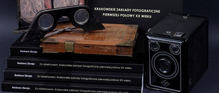 Kompozycja kilku książek wraz z akcesoriami: stary aparat, okular.