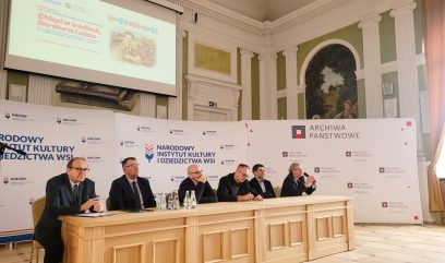 6 osób siedzi za stołem konferencyjnym.