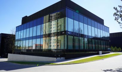 The Archive building is in an industrial style with large glass walls.