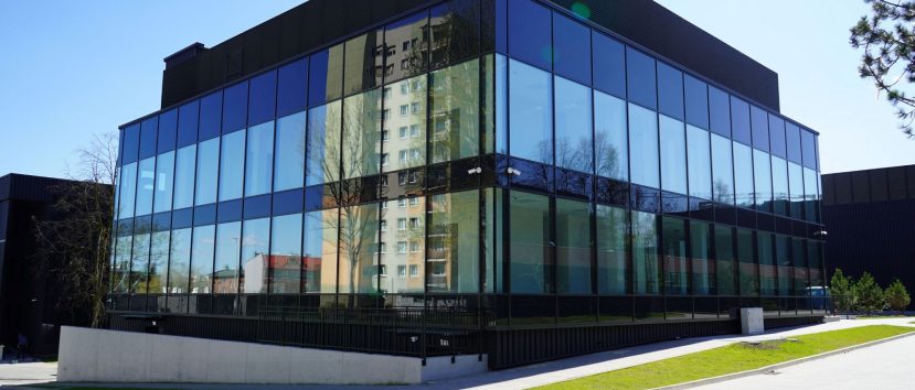 The Archive building is in an industrial style with large glass walls.