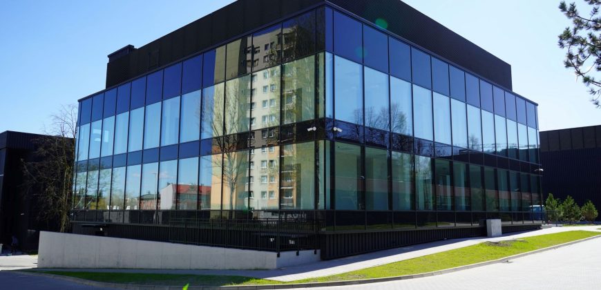 The Archive building is in an industrial style with large glass walls.