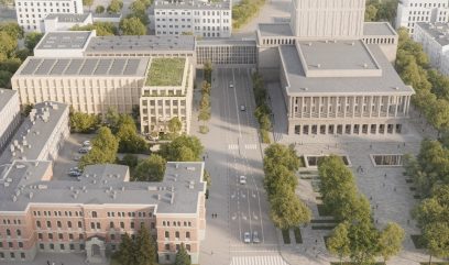 Aerial view of a city area with wide streets, trees, and several large buildings, including a modern rectangular building with a green roof, a brick building with arched windows, and a tall building with columns and stairs, surrounded by greenery.