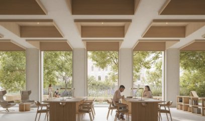 A modern library with large windows revealing the green trees outside. Two people sit at a wooden table, studying. Wooden chairs, bookshelves, and armchairs fill the bright, airy room. Square panels with lighting adorn the ceiling.